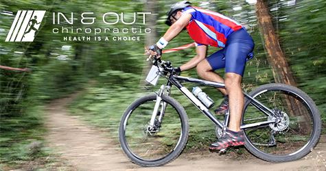 A man speeds around the curve on a dirt path on a mountain bike.