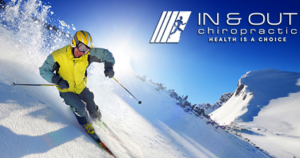 A man skis down a slope, the In & Out Chiropractic logo hovers in the corner