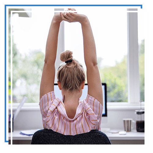 woman stretching at desk